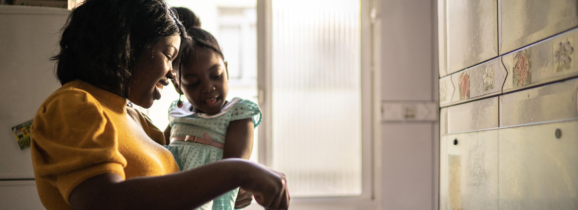 Mother and daughter cooking.